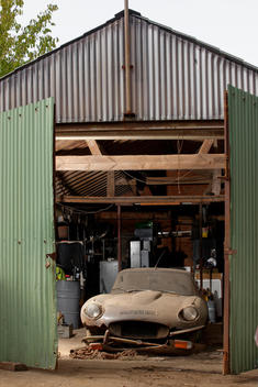 barn find image of E-Type Jaguar behind old garage doors