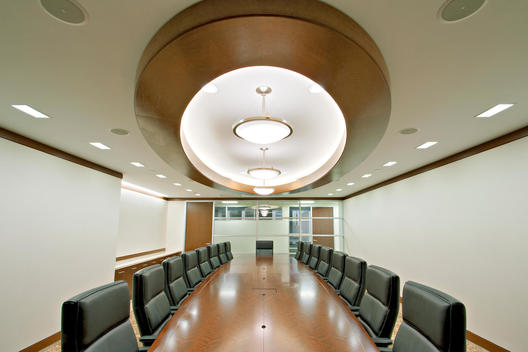 Conference Room With Fitted Oriental Carpet, Black Leather Chairs, Wood Trimmed Ceiling Fixtures