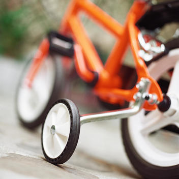 Child\'s bike with training wheels, close up