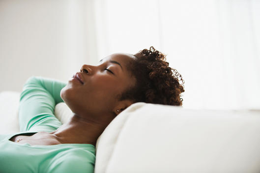 African woman napping on sofa
