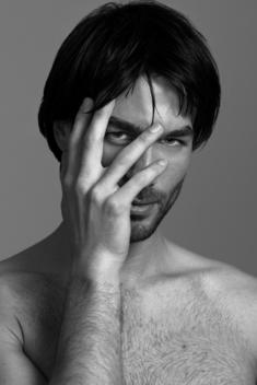 Portrait Of Male Model Holding Fingers Over Eye