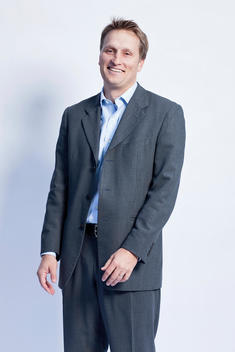 Portrait of young, 35-40 year old, caucasian, professional man in studio wearing business attire