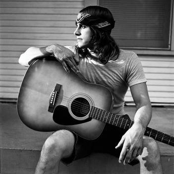 Portrait of a man holding his guitar, Austin, Texas, USA.
