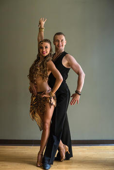 A man and woman dancing together in a dance studio.