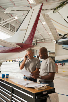 Men working in airplane hangar