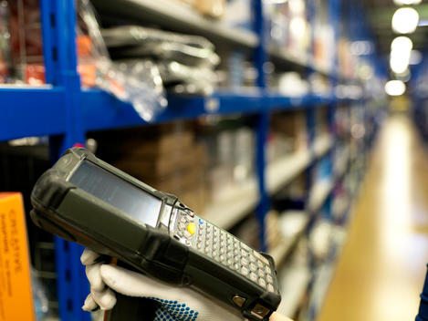 Stock Scan Gun In Warehouse Aisle