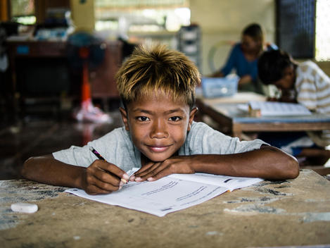 A boy does schoolwork at The Wat Opot Community, an orphanage for children affected by HIV and AIDS, near Chambak, Cambodia, outside Phnom Penh.