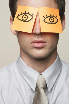 Business Man With Post-It Notes On Eyes