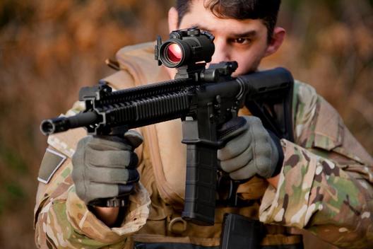 Soldier aiming automatic weapon during training
