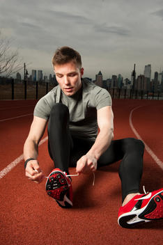 Runner Lacing Shoes On Track.