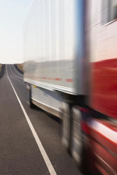 Blurred view of truck driving on remote highway
