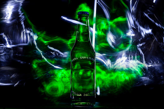 Glass bottle of beer with light painting effects.
