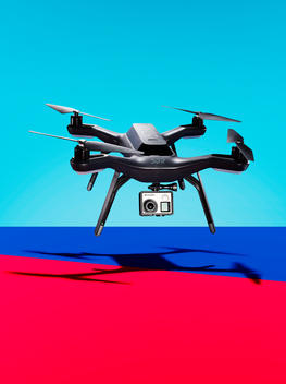 Floating drone on blue and red background