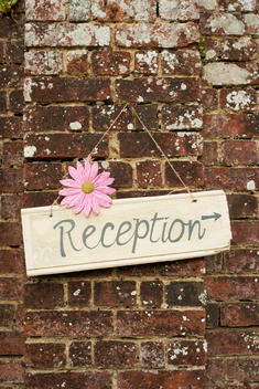 \'Reception\' sign on brick wall