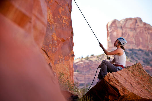 Young Woman Belaying Her Climbing Partner