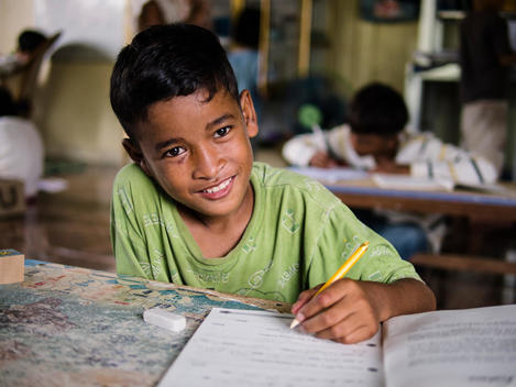 A boy does schoolwork at The Wat Opot Community, an orphanage for children affected by HIV and AIDS, near Chambak, Cambodia, outside Phnom Penh.