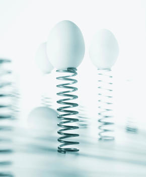 Eggs Balancing On Wire Spring Coils.