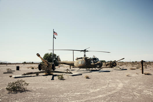 old helicopter and canons in desert
