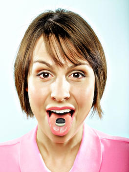 Woman with candy on her tongue