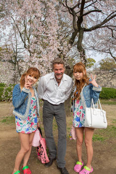 women dressed as schoolgirls with American friend and cherry blossoms