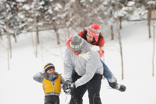 Black family playing in snow