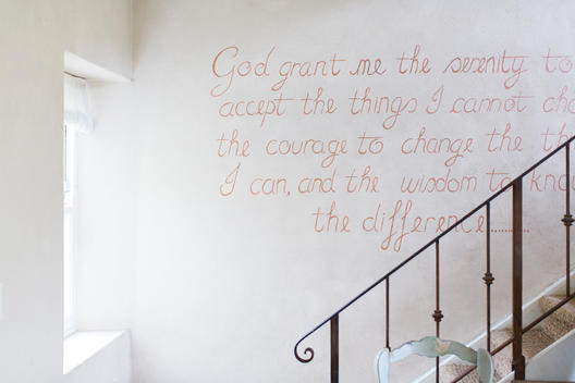 Quote on wall of rustic house