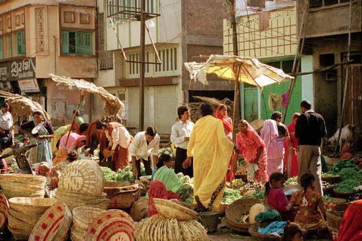 Vendors Of Indian Appearance Sell Produce At Market