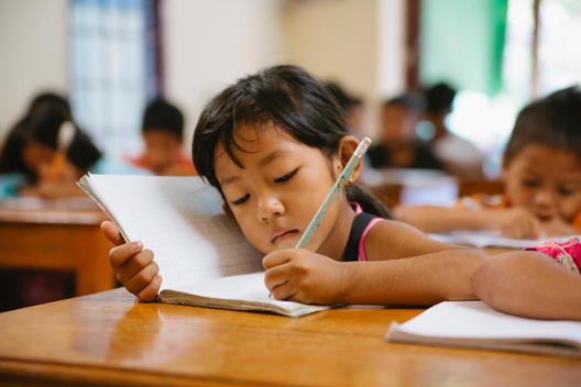 A child does schoolwork at Empowering Youth in Cambodia's Impact School in Phnom Penh, Cambodia.