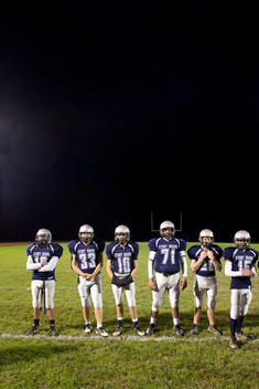 High school football players lined up on field