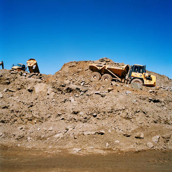 Dump Truck Hauling Dirt At Construction Site