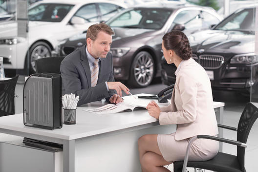 At the car dealer, Salesman talking to client
