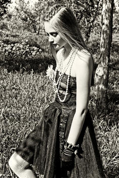 Model walking in forest wearing lace in a black and white gothic style image