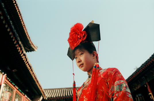 A Chinese Waitress Parades Around Wearing Traditional Chinese Garb.