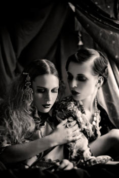 Close up of two young adult females gazing at each other with Bohemian clothing