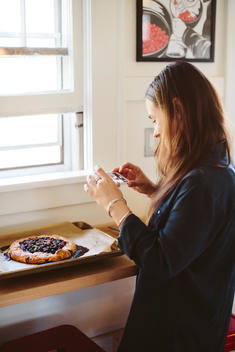 Woman taking a photo of freshly baked pie