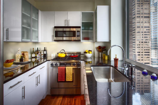 Granite-Topped Kitchen With City View And A Variety Of Kitchen Supplies