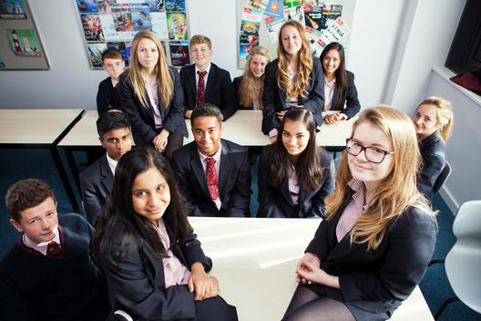 Group portrait of teenage schoolchildren in class