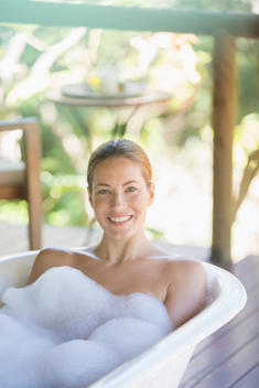 Woman relaxing in bubble bath