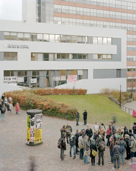 Students outside the Student Union building at The University of Sheffield while other students hold a sit-in protest in the Hicks Building against rise in tuition fees. Their protest banners can be seen in the windows.