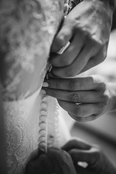 bride getting dressed, white dress with lace
