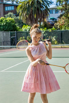 girl holding badminton racquets