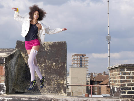Fashion Story Based On A Theme Of Urban Street Wear, Photographed On An East London Rooftop, Female Model Jumping Wearing A Colorful Outfit