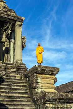 Young Buddhist monk standing outside temple in Angkor Wat, Siem Reap, Cambodia