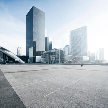 A single person walking in a futuristic city. La Defense, Paris