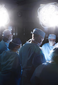 Team of doctors operating on patient