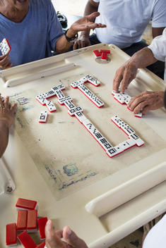overhead view of old people playing dominos in Maximo Gomez Park aka Dominoes Park