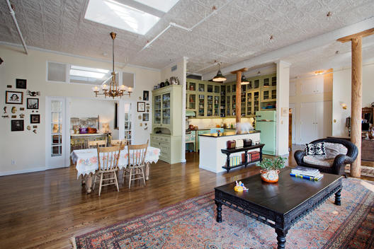 Wide Shot Of Living Room With Many Odd Details, Skylights, Tin Ceiling, Green Kitchen, Small Dining Room Table