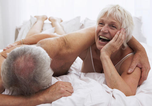 Senior Couple Laughing In Bed