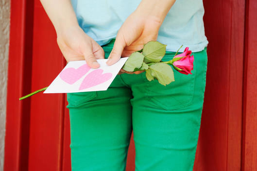 Close Up Of Man At Door With Valentines Card And Rose