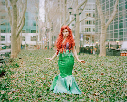 Portrait of Brittney, an ordinary woman who works as and impersonates Disney Princess Ariel from the Little Mermaid in Bryant Park. New York, NY